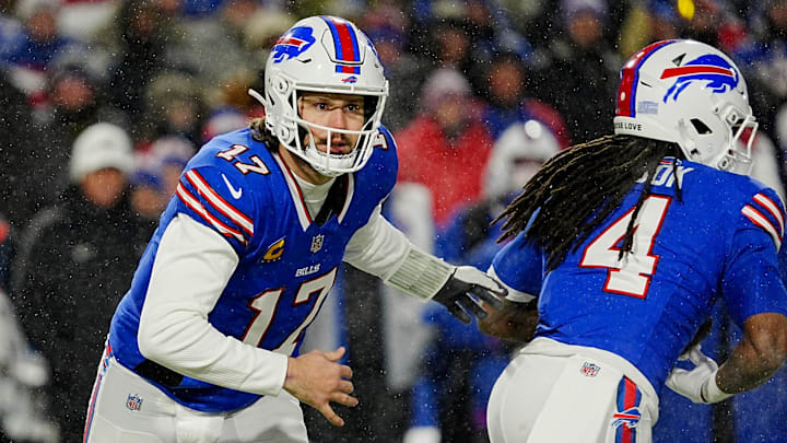 Buffalo Bills quarterback Josh Allen heads in the opposite direction of Buffalo Bills running back James Cook who he handed the ball off to during first half action at the Buffalo Bills divisional game against the Baltimore Ravens at Highmark Stadium in Orchard Park on Jan. 19, 2025.