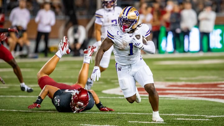 Jonah Coleman leaves a WSU player face down on the turf in Pullman.