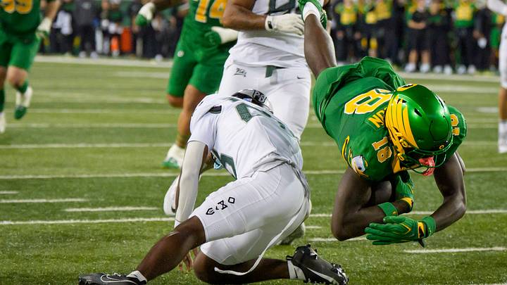 Oregon tight end Kendre Harrison, right, dives over Portland State safety Dionte West for a touchdown as the Oregon Ducks host the Portland State Vikings on Sept. 18, 2026, at Autzen Stadium in Eugene, Oregon.