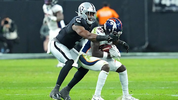 Jan 7, 2024; Paradise, Nevada, USA; Denver Broncos wide receiver Brandon Johnson (89) is tackled by Las Vegas Raiders linebacker Divine Deablo (5) during the fourth quarter at Allegiant Stadium. Mandatory Credit: Stephen R. Sylvanie-USA TODAY Sports
