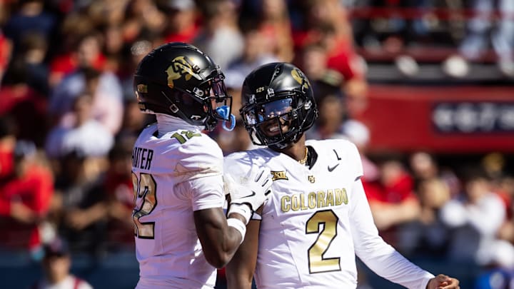 Oct 19, 2024; Tucson, Arizona, USA; Colorado Buffalos quarterback Shedeur Sanders (2) with wide receiver Travis Hunter (12) against the Arizona Wildcats at Arizona Stadium. Mandatory Credit: Mark J. Rebilas-Imagn Images