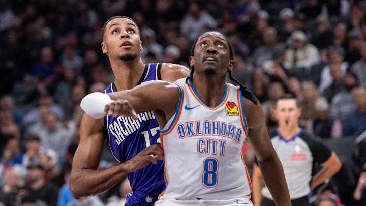 Nov 25, 2024; Sacramento, California, USA; Oklahoma City Thunder forward Jalen Williams (8) and Sacramento Kings forward Keegan Murray (13) fight for position under the basket during the second quarter at Golden 1 Center. Mandatory Credit: Ed Szczepanski-Imagn Images