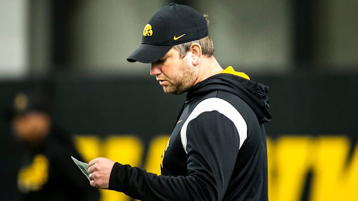 Jon Budmayr, senior special assistant to the head coach, looks at notes during a spring NCAA football practice, Thursday, March 30, 2023, at the University of Iowa Indoor Practice Facility in Iowa City, Iowa.

230330 Iowa Spring Fb 069 Jpg