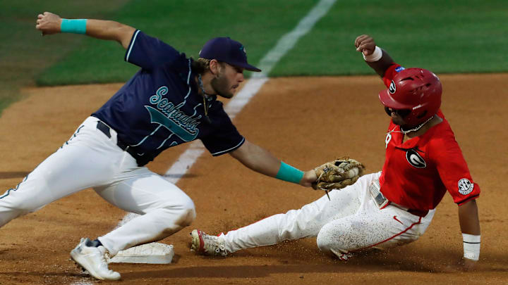 Georgia's Clayton Chadwick (8) slides into steal third base during a NCAA Athens Regional baseball game against UNCW in Athens, Ga., on Saturday, June 1, 2024. Georgia won 11-2.