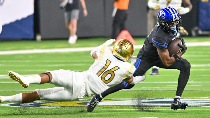 Oct 8, 2022; Paradise, Nevada, USA; Notre Dame Fighting Irish safety Brandon Joseph (16) attempts to tackle BYU Cougars wide receiver Kody Epps (0) in the fourth quarter at Allegiant Stadium. Mandatory Credit: Matt Cashore-Imagn Images Oct 8, 2022; Paradise, Nevada, USA; Notre Dame Fighting Irish safety Brandon Joseph (16) attempts to tackle BYU Cougars wide receiver Kody Epps (0) in the fourth quarter at Allegiant Stadium. Mandatory Credit: Matt Cashore-Imagn Images