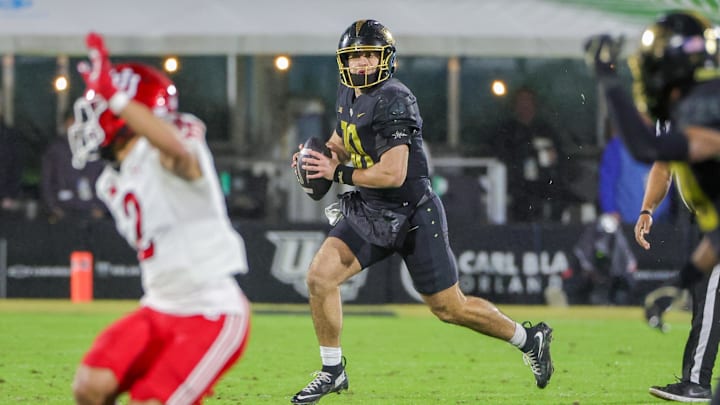 Nov 29, 2024; Orlando, Florida, USA; UCF Knights quarterback Dylan Rizk (10) carries the ball during the second quarter against the Utah Utes at FBC Mortgage Stadium. Mandatory Credit: Mike Watters-Imagn Images Nov 29, 2024; Orlando, Florida, USA; UCF Knights quarterback Dylan Rizk (10) carries the ball during the second quarter against the Utah Utes at FBC Mortgage Stadium. Mandatory Credit: Mike Watters-Imagn Images