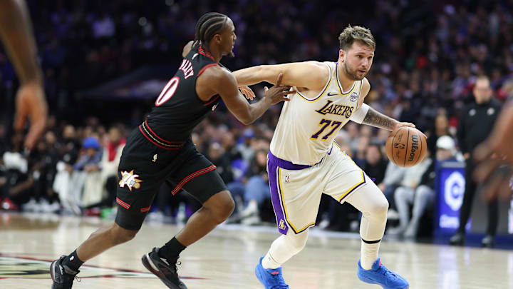 Dec 7, 2025; Philadelphia, Pennsylvania, USA; Los Angeles Lakers guard Luka Doncic (77) dribbles past Philadelphia 76ers guard Tyrese Maxey during the second quarter at Xfinity Mobile Arena. Mandatory Credit: Bill Streicher-Imagn Images Dec 7, 2025; Philadelphia, Pennsylvania, USA; Los Angeles Lakers guard Luka Doncic (77) dribbles past Philadelphia 76ers guard Tyrese Maxey during the second quarter at Xfinity Mobile Arena. Mandatory Credit: Bill Streicher-Imagn Images