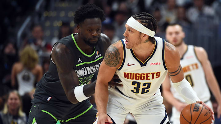 Apr 18, 2026; Denver, Colorado, USA; Denver Nuggets forward Aaron Gordon (32) handles the ball against Minnesota Timberwolves forward Julius Randle (30) during the first half in game one of the first round of the 2026 NBA Playoffs at Ball Arena. 