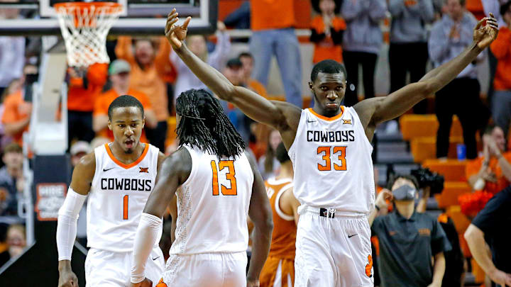 Oklahoma State's Bryce Thompson (1), Isaac Likekele (13) and Moussa Cisse (33) celebrates a victory vs. Texas.