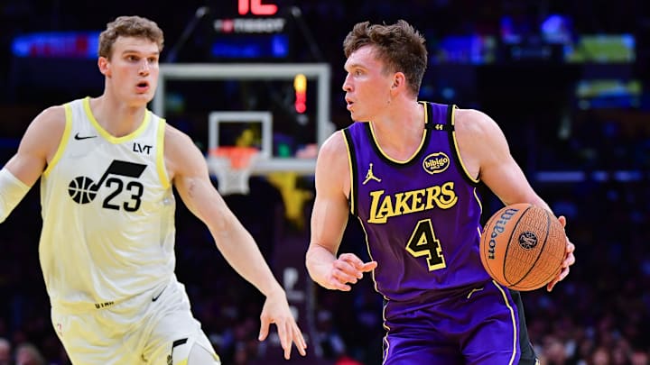 Nov 19, 2024; Los Angeles, California, USA; Los Angeles Lakers guard Dalton Knecht (4) moves to the basket agianst Utah Jazz forward Lauri Markkanen (23) during the first half at Crypto.com Arena. Mandatory Credit: Gary A. Vasquez-Imagn Images Nov 19, 2024; Los Angeles, California, USA; Los Angeles Lakers guard Dalton Knecht (4) moves to the basket agianst Utah Jazz forward Lauri Markkanen (23) during the first half at Crypto.com Arena. Mandatory Credit: Gary A. Vasquez-Imagn Images