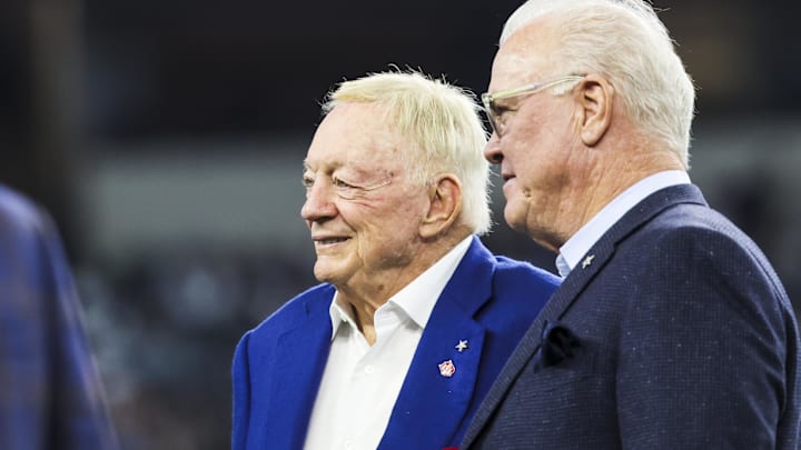 Dallas Cowboys co-owners Jerry Jones and Stephen Jones stand on the field during pregame warmups.