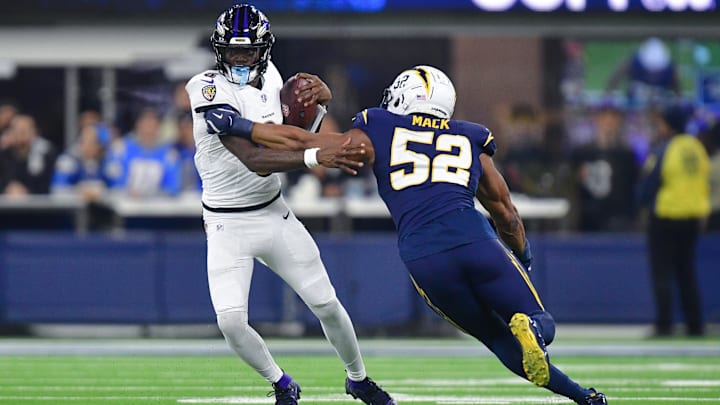 Baltimore Ravens quarterback Lamar Jackson (8) runs the ball against Los Angeles Chargers linebacker Khalil Mack (52) during the second half at SoFi Stadium. 