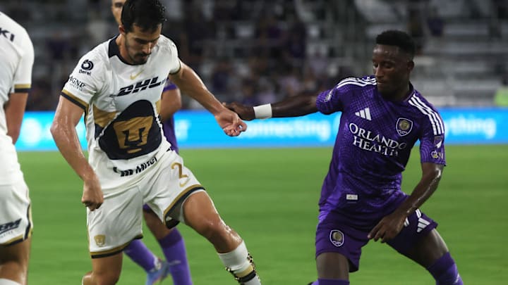Jul 30, 2025; Orlando, Florida, USA; Pumas UNAM defender Pablo Bennevendo (2) dribbles the ball against Orlando City forward Ramiro Enrique (7) during the second half at Inter&Co Stadium. Mandatory Credit: Kim Klement Neitzel-Imagn Images