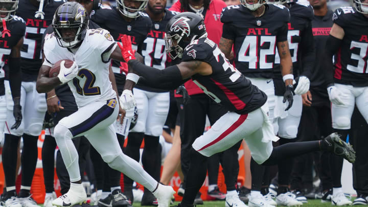 Baltimore Ravens wide receiver Malik Cunningham (12) gains yards after a second quarter catch defended by Atlanta Falcons safety Tre Tarpley III (38) at M&T Bank Stadium. Baltimore Ravens wide receiver Malik Cunningham (12) gains yards after a second quarter catch defended by Atlanta Falcons safety Tre Tarpley III (38) at M&T Bank Stadium.
