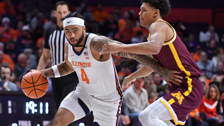 Jan 17, 2026; Champaign, Illinois, USA;  Illinois Fighting Illini guard Kylan Boswell (4) drives the ball around Minnesota Golden Gophers guard Isaac Asuma (1) during the first half at State Farm Center. Mandatory Credit: Ron Johnson-Imagn Images