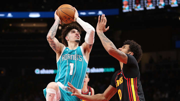 Mar 12, 2025; Atlanta, Georgia, USA; Charlotte Hornets guard LaMelo Ball (1) shoots against Atlanta Hawks forward Dominick Barlow (0) during the second half at State Farm Arena. Mandatory Credit: Mady Mertens-Imagn Images