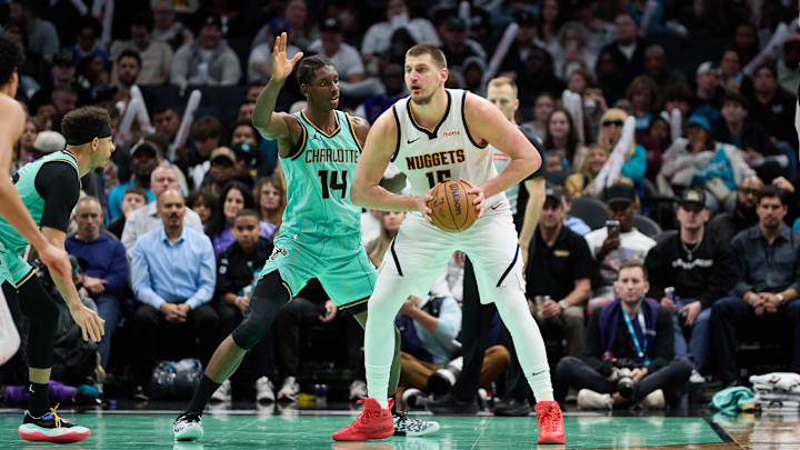 Feb 1, 2025; Charlotte, North Carolina, USA; Denver Nuggets center Nikola Jokic (15) is defended by Charlotte Hornets forward Moussa Diabate (14) during the second half of play at Spectrum Center. Mandatory Credit: Brian Westerholt-Imagn Images