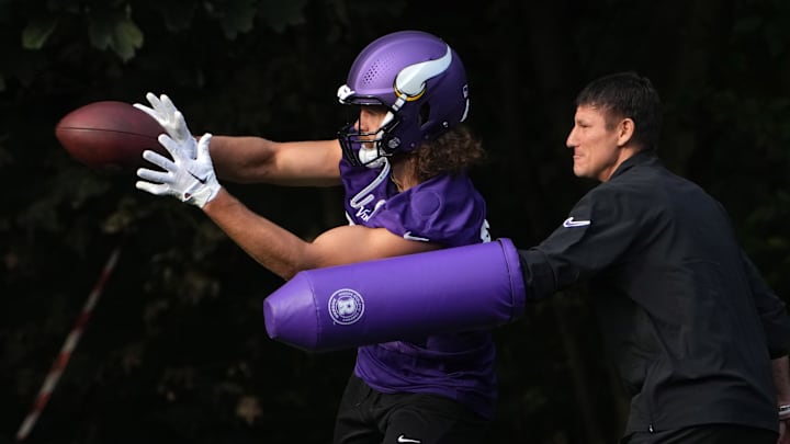 Oct 4, 2024; Watford, United Kingdom; Minnesota Vikings tight end T.J. Hockenson (87) catches the ball against tight ends coach Brian Angelichio during practice at The Grove. Oct 4, 2024; Watford, United Kingdom; Minnesota Vikings tight end T.J. Hockenson (87) catches the ball against tight ends coach Brian Angelichio during practice at The Grove.