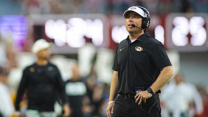 Oct 26, 2024; Tuscaloosa, Alabama, USA; Missouri Tigers head coach Eliah Drinkwitz talks into his headset during a timeout against the Alabama Crimson Tide in the fourth quarter at Bryant-Denny Stadium. Mandatory Credit: Will McLelland-Imagn Images
