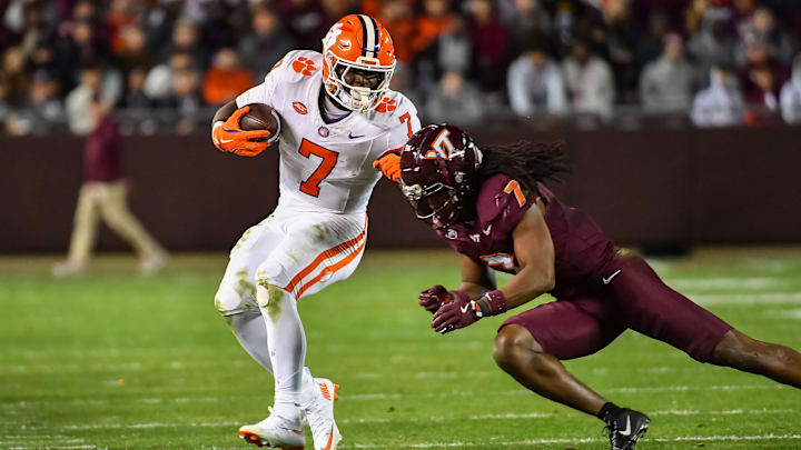 Nov 9, 2024; Blacksburg, Virginia, USA;  Virginia Tech Hokies linebacker Keonta Jenkins (7) dives to tackle Clemson Tigers running back Phil Mafah (7) during the fourth quarter at Lane Stadium. Mandatory Credit: Brian Bishop-Imagn Images