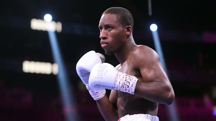 Oct 9, 2021; Las Vegas, Nevada, USA; Cesar Cantu (white/blue trunks) and Bruce Carrington (red/white trunks) during their featherweight boxing match at T-Mobile Arena. Mandatory Credit: Joe Camporeale-Imagn Images