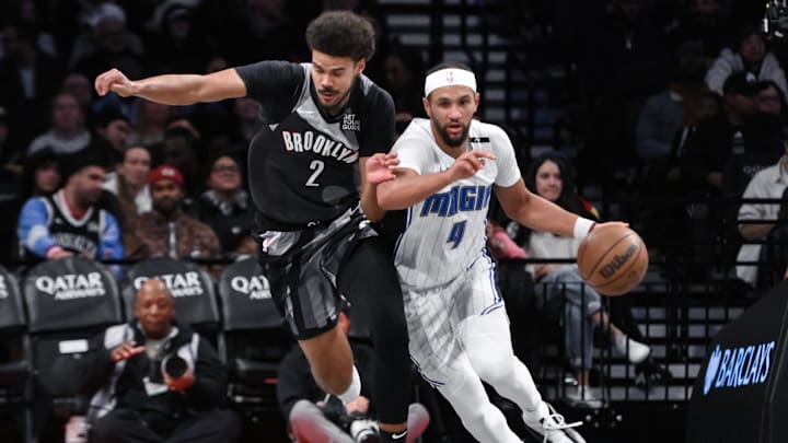 Orlando Magic guard Jalen Suggs (4) brings the ball up court while being defended by Brooklyn Nets forward Cameron Johnson (2) during the first half at Barclays Center.