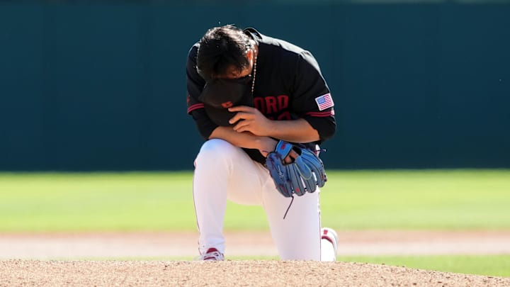 Mar 1, 2025; Stanford, CA, USA; Stanford Cardinal starting pitcher Christian Lim (42) kneels behind the mound before the game against the Xavier Musketeers at Sunken Diamond. Mandatory Credit: Darren Yamashita-Imagn Images