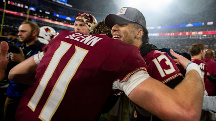 Florida State Seminoles quarterback Jordan Travis (13) hugs Florida State Seminoles quarterback