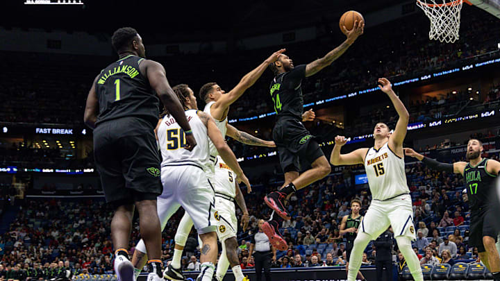 Nov 17, 2023; New Orleans, Louisiana, USA;  New Orleans Pelicans forward Brandon Ingram (14) drives to the basket against Denver Nuggets center Nikola Jokic (15) during the second half at the Smoothie King Center. Mandatory Credit: Stephen Lew-Imagn Images