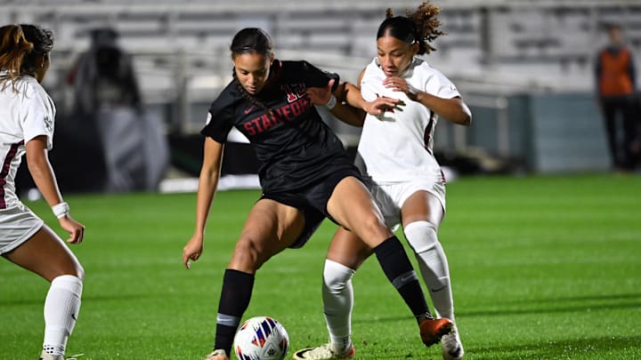 Dec 4, 2023; Cary, NC, USA; Stanford midfielder Jasmine Aikey (12) with the ball as Florida St. midfielder Ran Iwai (7) and forward Leilanni Nesbeth (13) defend in the first half at WakeMed Soccer Park. Mandatory Credit: Bob Donnan-Imagn Images