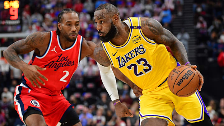 Feb 4, 2025; Inglewood, California, USA; Los Angeles Lakers forward LeBron James (23) moves the ball against Los Angeles Clippers forward Kawhi Leonard (2) during the second half at Intuit Dome. Mandatory Credit: Gary A. Vasquez-Imagn Images