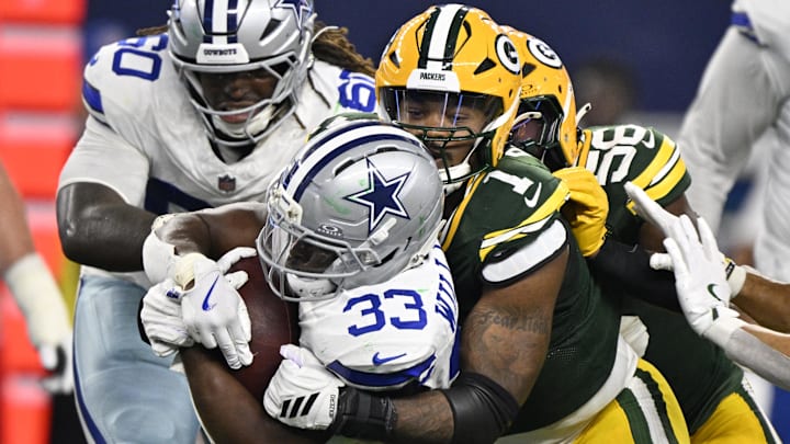 Green Bay Packers defensive end Micah Parsons (1) tackles Dallas Cowboys running back Javonte Williams (33) in the third quarter at AT&T Stadium.