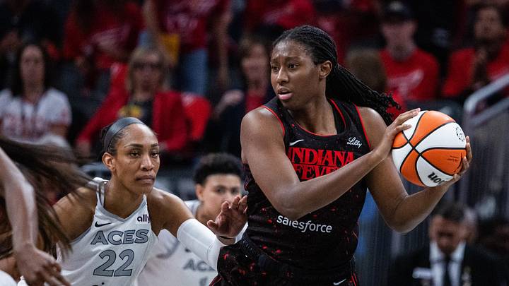 Sep 28, 2025; Indianapolis, Indiana, USA; Indiana Fever forward Aliyah Boston (7) holds the ball while Las Vegas Aces center A'ja Wilson (22) defends in the second half  during game four of the second round for the 2025 WNBA Playoffs at Gainbridge Fieldhouse. Mandatory Credit: Trevor Ruszkowski-Imagn Images