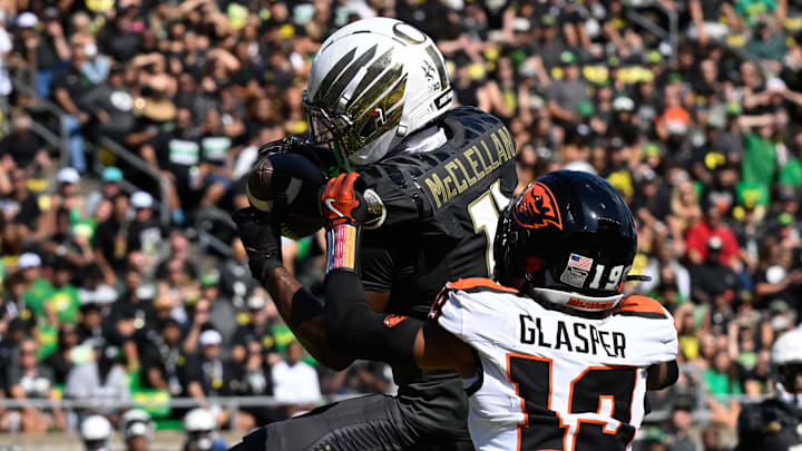 Sep 20, 2025; Eugene, Oregon, USA; Oregon Ducks wide receiver Jeremiah McClellan (11) makes a reception for a touchdown defended by Oregon State Beavers defensive back Trey Glasper (19) during the third quarter of the game at Autzen Stadium. Mandatory Credit: Troy Wayrynen-Imagn Images
