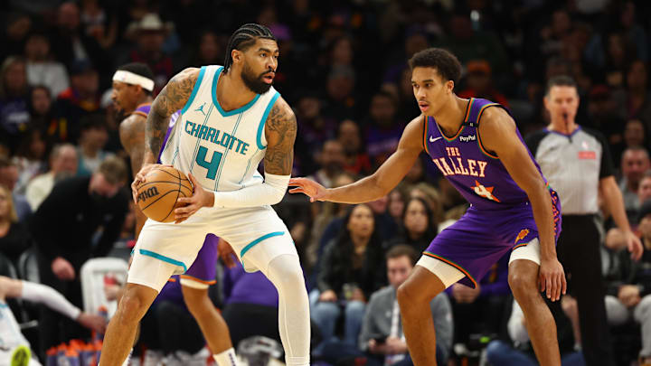 Jan 12, 2025; Phoenix, Arizona, USA; Charlotte Hornets center Nick Richards (left) against Phoenix Suns center Oso Ighodaro at Footprint Center. Mandatory Credit: Mark J. Rebilas-Imagn Images