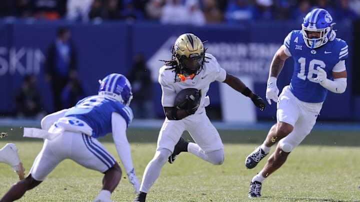 Nov 29, 2025; Provo, Utah, USA; UCF Knights wide receiver Duane Thomas Jr. (7) runs against BYU Cougars defensive back Evan Johnson (0) and BYU Cougars linebacker Isaiah Glasker (16) during the first quarter at LaVell Edwards Stadium. Mandatory Credit: Rob Gray-Imagn Images Nov 29, 2025; Provo, Utah, USA; UCF Knights wide receiver Duane Thomas Jr. (7) runs against BYU Cougars defensive back Evan Johnson (0) and BYU Cougars linebacker Isaiah Glasker (16) during the first quarter at LaVell Edwards Stadium. Mandatory Credit: Rob Gray-Imagn Images