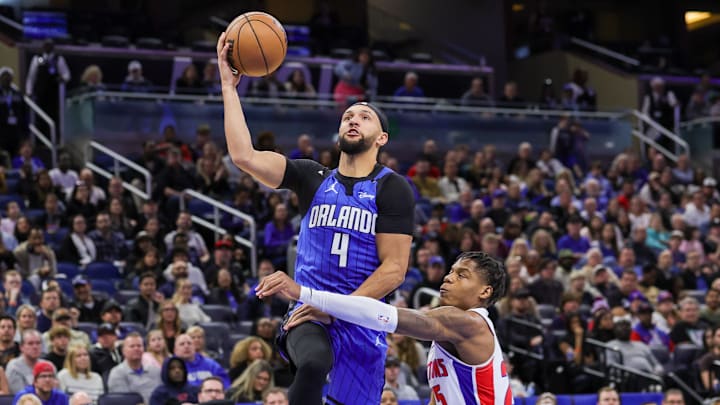 Jan 25, 2025; Orlando, Florida, USA; Orlando Magic guard Jalen Suggs (4) is fouled by Detroit Pistons guard Marcus Sasser (25) during the second half at Kia Center. Mandatory Credit: Mike Watters-Imagn Images