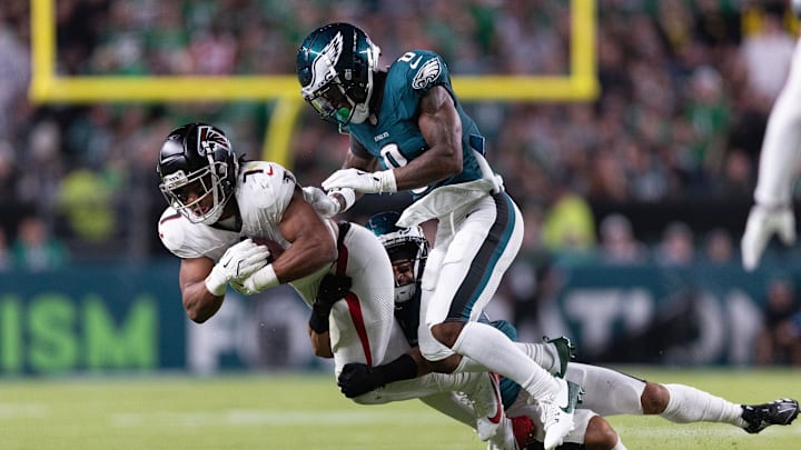 Sep 16, 2024; Philadelphia, Pennsylvania, USA; Philadelphia Eagles defensive end Bryce Huff (0) tackles Atlanta Falcons running back Bijan Robinson (7) after a catch during the second quarter at Lincoln Financial Field. Mandatory Credit: Bill Streicher-Imagn Images