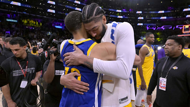 May 12, 2023; Los Angeles, California, USA; Los Angeles Lakers forward Anthony Davis (3) and Golden State Warriors guard Stephen Curry (30) embrace after game six of the 2023 NBA playoffs at Crypto.com Arena. Mandatory Credit: Jayne Kamin-Oncea-Imagn Images