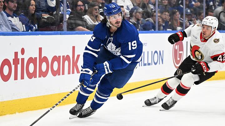 Sep 23, 2026; Toronto, Ontario, CAN;  Toronto Maple Leafs forward Zack MacEwen (19) skates the puck away from Ottawa Senators forward Hayden Hodgson (42) in the second period at Scotiabank Arena.  Mandatory Credit: Dan Hamilton-Imagn Images