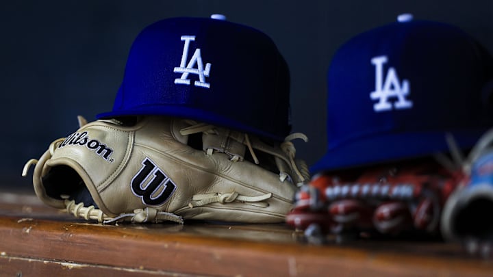 Jul 30, 2025; Cincinnati, Ohio, USA; A general view of a Los Angeles Dodgers hat and glove during the second inning in the game against the Cincinnati Reds at Great American Ball Park. Mandatory Credit: Katie Stratman-Imagn Images