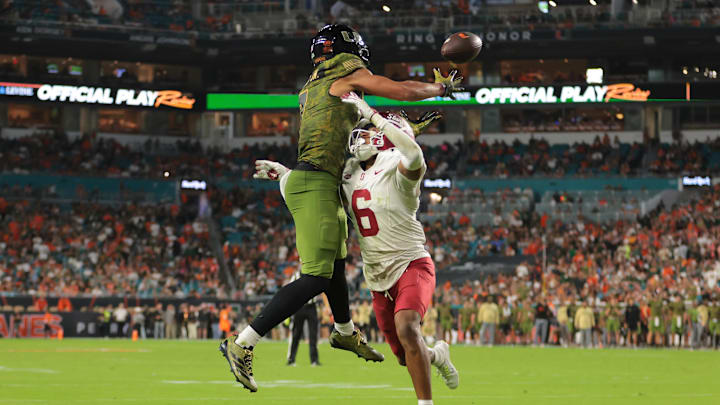 Oct 25, 2025; Miami Gardens, Florida, USA; Miami Hurricanes wide receiver CJ Daniels (7) catches the football for a touchdown against Stanford Cardinal cornerback Jay Green (5) during the second quarter at Hard Rock Stadium. Mandatory Credit: Sam Navarro-Imagn Images