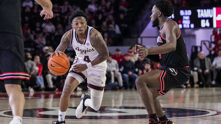 Texas A&M Aggies guard Wade Taylor IV (4) dribbles against Georgia Bulldogs guard Noah Thomasson (3) 