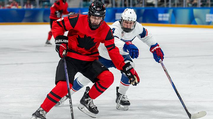 Jan 30, 2024; Gangwon-do, KOR; Tynan Lawrence (CAN) skates with the puck while under pressure from AJ Francisco (USA) in the Ice Hockey Men s 6-on-6 Tournament Semifinals between Canada and (USA) at the Gangneung Hockey Centre. The Winter Youth Olympic Games, Gangwon, South Korea, Tuesday 30 January 2024. Mandatory Credit: OIS/Thomas Lovelock-Imagn Images