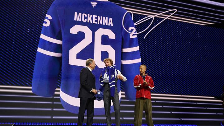 Jun 26, 2026; Buffalo, New York, USA; Gavin McKenna puts on a sweater beside NHL commissioner Gary Bettman and singer Justin Bieber after being selected with the first pick in the first round of the 2026 NHL Draft by the Toronto Maple Leafs at KeyBank Center. Mandatory Credit: Timothy T. Ludwig-Imagn Images Jun 26, 2026; Buffalo, New York, USA; Gavin McKenna puts on a sweater beside NHL commissioner Gary Bettman and singer Justin Bieber after being selected with the first pick in the first round of the 2026 NHL Draft by the Toronto Maple Leafs at KeyBank Center. Mandatory Credit: Timothy T. Ludwig-Imagn Images