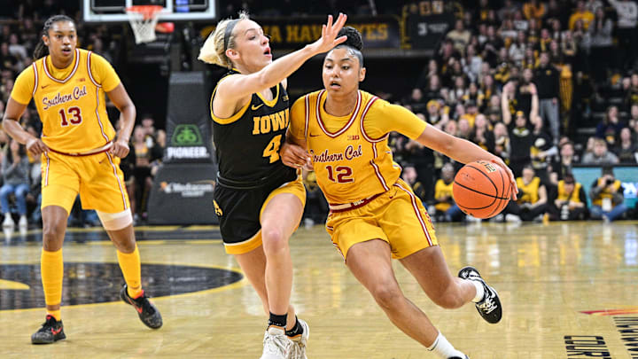 Feb 2, 2025; Iowa City, Iowa, USA; USC Trojans guard JuJu Watkins (12) drives with the ball as Iowa Hawkeyes guard Kylie Feuerbach (4) defends and center Rayah Marshall (13) looks on during the first quarter at Carver-Hawkeye Arena. Mandatory Credit: Jeffrey Becker-Imagn Images Feb 2, 2025; Iowa City, Iowa, USA; USC Trojans guard JuJu Watkins (12) drives with the ball as Iowa Hawkeyes guard Kylie Feuerbach (4) defends and center Rayah Marshall (13) looks on during the first quarter at Carver-Hawkeye Arena. Mandatory Credit: Jeffrey Becker-Imagn Images