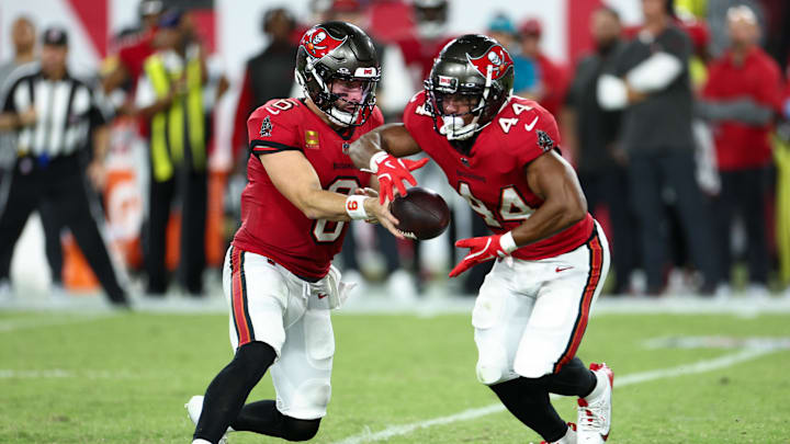 Oct 21, 2024; Tampa, Florida, USA; Tampa Bay Buccaneers quarterback Baker Mayfield (6) hands off to running back Sean Tucker (44) against the Baltimore Ravens in the second quarter at Raymond James Stadium. Mandatory Credit: Nathan Ray Seebeck-Imagn Images Oct 21, 2024; Tampa, Florida, USA; Tampa Bay Buccaneers quarterback Baker Mayfield (6) hands off to running back Sean Tucker (44) against the Baltimore Ravens in the second quarter at Raymond James Stadium. Mandatory Credit: Nathan Ray Seebeck-Imagn Images