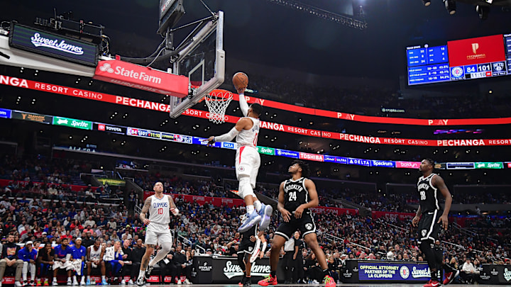 Jan 21, 2024; Los Angeles, California, USA; Los Angeles Clippers guard Russell Westbrook (0) moves to the basket against Brooklyn Nets guard Cam Thomas (24) during the second half at Crypto.com Arena. Mandatory Credit: Gary A. Vasquez-Imagn Images