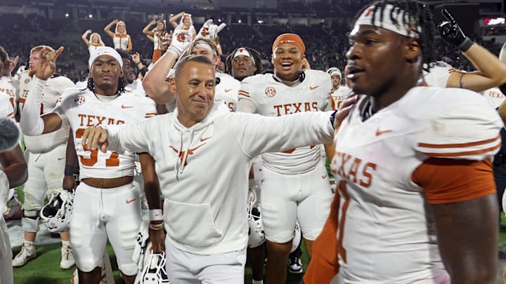 Oct 25, 2025; Starkville, Mississippi, USA; Texas Longhorns head coach Steve Sarkisian reacts with defensive linemen Colin Simmons (1) after beating the Mississippi State Bulldogs in overtime at Davis Wade Stadium at Scott Field. Mandatory Credit: Petre Thomas-Imagn Images