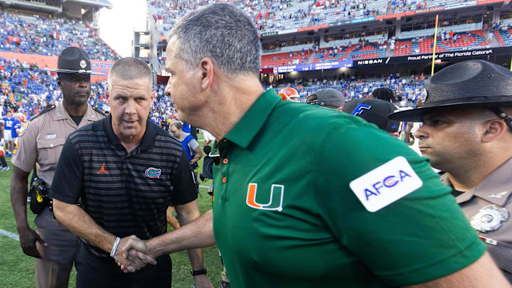 Florida Gators head coach Billy Napier, left shakes hands with Miami Hurricanes head coach Mario Cristobal after the Hurricanes defeated the Gators during the season opener at Ben Hill Griffin Stadium in Gainesville, FL on Saturday, August 31, 2024 against the University of Miami Hurricanes. The Hurricanes defeated the Gators 41-17. [Doug Engle/Gainesville Sun]